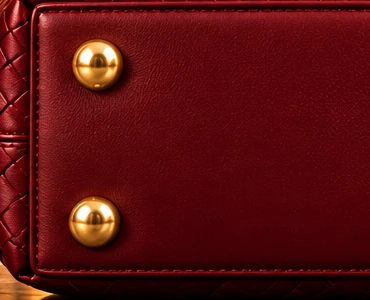 DK Shanghai. Gold-tone hardware: Protective gold-tone feet beneath a structured base.